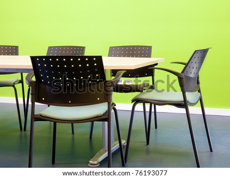 Green office furnished in table and chairs