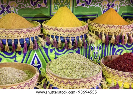 Heap of colorful, powdered spices in african boxes