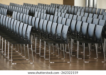 Rows of empty chairs prepared for an indoor event