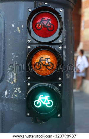 All three lights as a traffic sign in the city. Red orange green colored traffic lights as a background