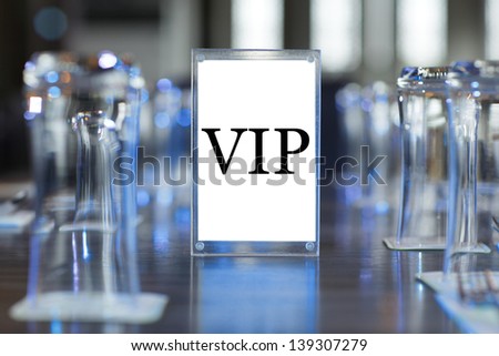 VIP tag on table in resterant with blue lighting and bokeh