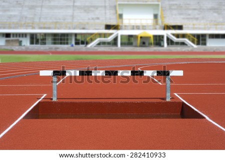 Black and white hurdles over water in track field