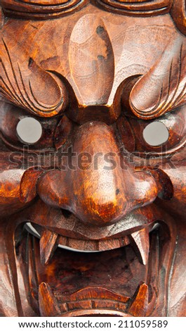 Close up japanese demon mask carving from wood