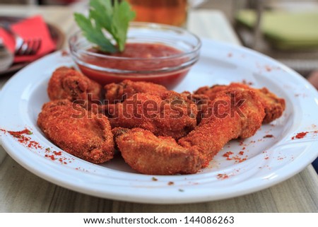 Mexican chicken wings served on a plate with ketchup