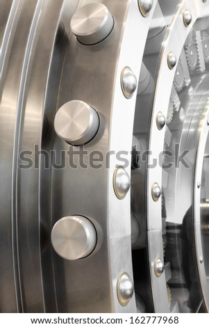 An open safe door in a vault