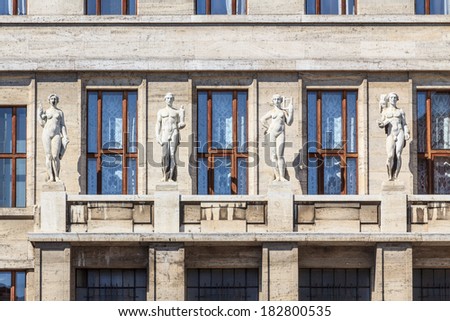 Four old greek statues of habits on an art nouveau building in Prague, Czech Republic
