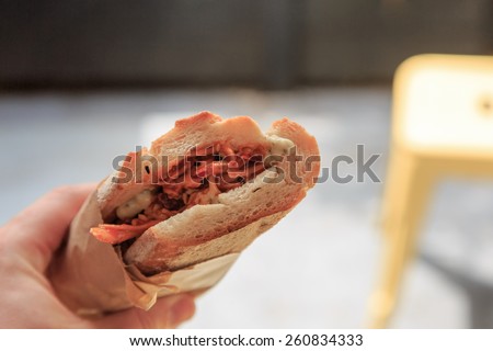 A sandwich with Chicken and sauce for lunch to go