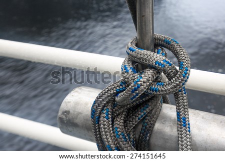 A thick knot tied at a ship in the rain