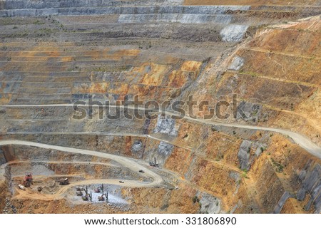 Bottom of surface mining and machinery in an open pit mine in Waihi, New Zealand