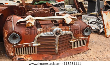 Old rusted car in junk yard . National park Death valley