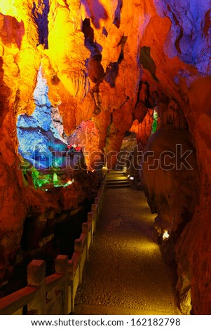 Beautiful illuminated multicolored stalactites from karst Reed Flute cave. Guilin Guangxi. China