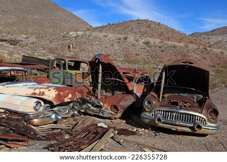 Old rusted car in junk yard . National park Death valley