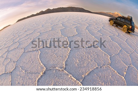 UYUNI - NOVEMBER  12:Tourists move on salt   desert Uyuni on off-road car  on November  12, 2014 in Uyuni, Bolivia. Desert Uyuni is one of the greatest salt deserts in the world