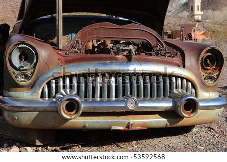 Stock Photo:  Old rusted car in junk yard . National park Death valley