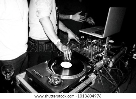 DJ spins records at a night club dance party