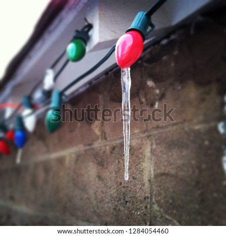 Icicle forming on vintage Christmas lights - cold winter
