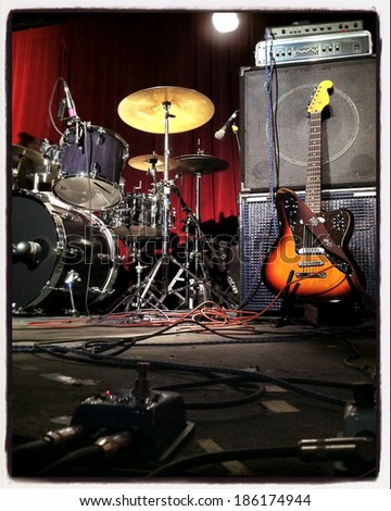 Instagram style image of a guitar and drums on stage