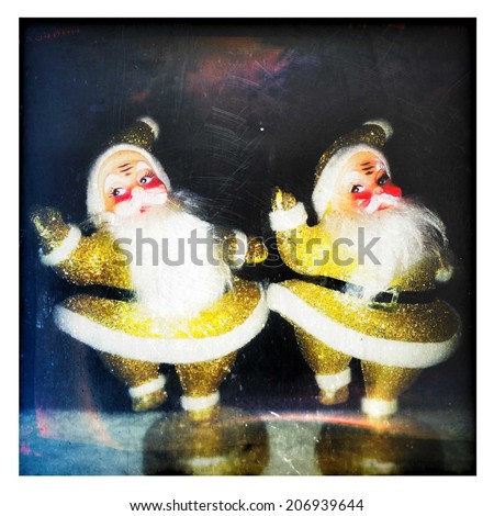 Instagram filtered style image of two glittery gold vintage dancing Santa Claus