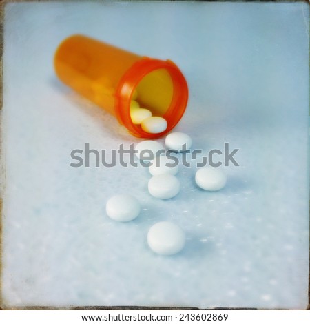 An Instagram filtered image of pills spilling from an prescription bottle