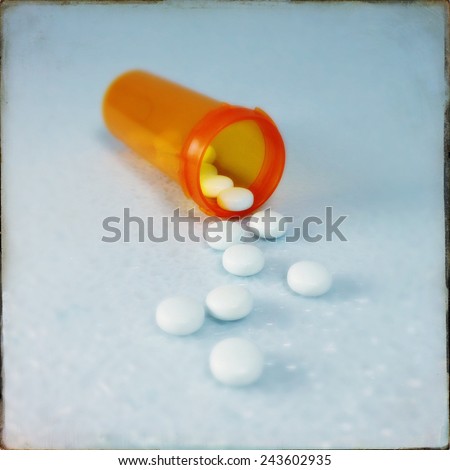 An Instagram filtered image of pills spilling from a prescription pill bottle