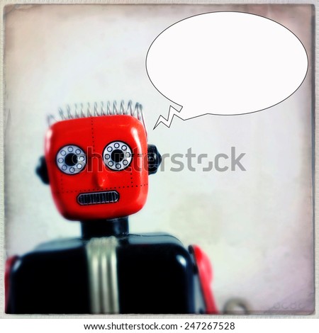 Instagram filtered image of a vintage toy robot with a thought bubble