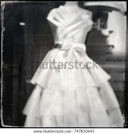 Vintage filtered image of a wedding bride gown on a mannequin in a shop window