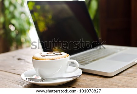 Coffee cup and laptop for business, Selective focus on coffee.