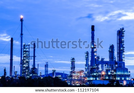 Petrochemical industry on sunset dark blue sky.
