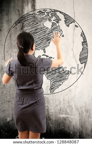 Business Lady touching world map drawing on the wall.