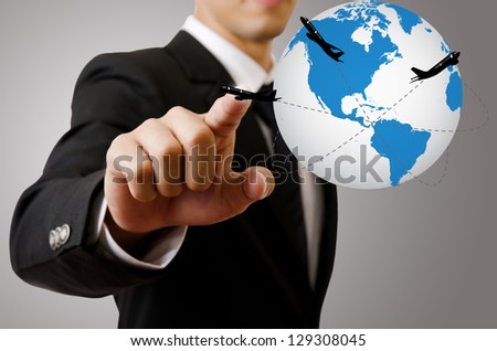 Businessman pushing World Map Globe for Business and Technology Concept. with airplane around the globe.