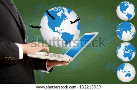Businessman pushing on laptop keyboard for Business Concept with World Map Globe. with airplane around the globe.