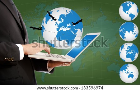 Businessman pushing on laptop keyboard for Business Concept with World Map Globe. with airplane around the globe.