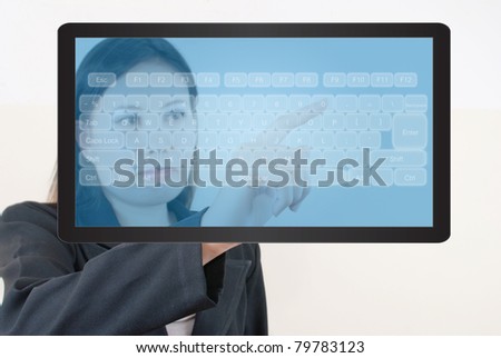 Business lady pressing transparent keyboard on the tablet screen.