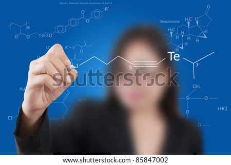Asian teacher lady writing scientific formula on the whiteboard.