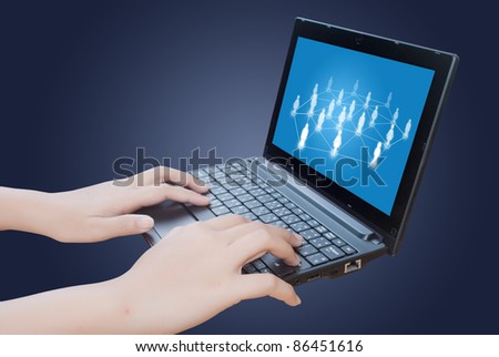 Hand pushing laptop keyboard with social network.