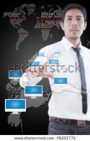 Businessman pushing Social Network world map with monitor.