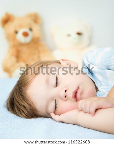 Cute little boy is sleeping on a white pillow Cute little boy is sleeping on a white pillow