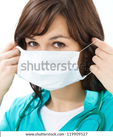 Portrait of a woman in doctor uniform wearing surgical mask