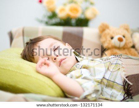 Portrait of a cute little boy sleeping on white pillow