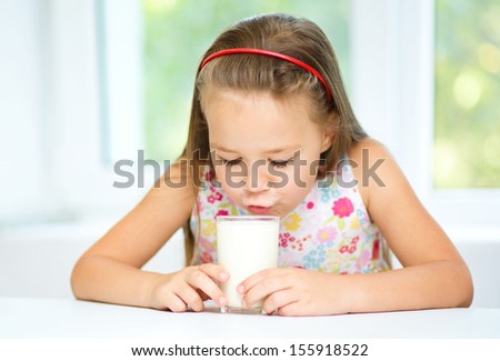 Cute little girl with a glass of milk