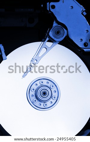 Hard drive interior, head on the disc surface, blue tint