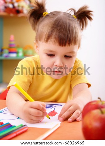 Cute little girl draw with felt-tip pen in preschool