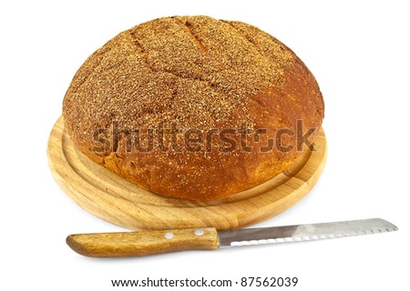 White wheat bread on a wooden board and a circular knife isolated on white background
