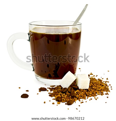 Coffee in a glass mug, a spoon, grains and granules of coffee on a table with two lumps of sugar isolated on white background