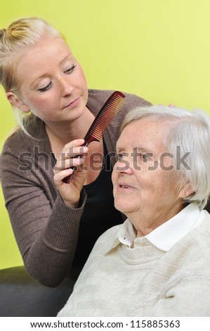 Senior woman with her caregiver in home. MANY OTHER PHOTOS WITH THIS SENIOR WOMAN IN MY PORTFOLIO.