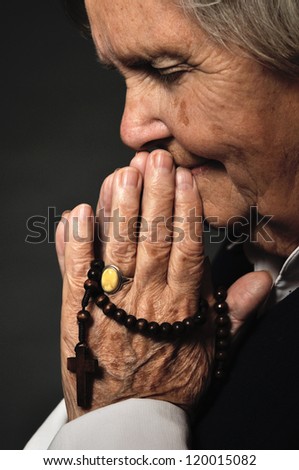 Praying senior woman with rosary beads. MANY OTHER PHOTOS FROM THIS SERIES IN MY PORTFOLIO - stock-photo-praying-senior-woman-with-rosary-beads-many-other-photos-from-this-series-in-my-portfolio-120015082