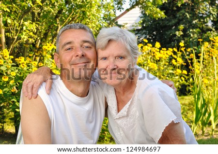 Happy mother and son in garden.