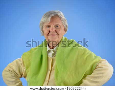 Senior happy woman with grey hairs against blue background. MANY OTHER PHOTOS FROM THIS SERIES IN MY PORTFOLIO.