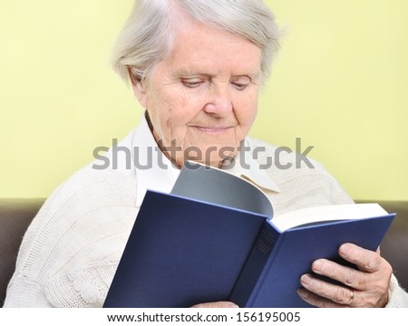 Senior woman reading book in home. MANY OTHER PHOTOS FROM THIS SERIES IN MY PORTFOLIO.