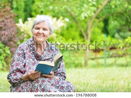 Senior woman reading book in park. MANY OTHER PHOTOS FROM THIS SERIES IN MY PORTFOLIO.